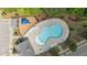 Aerial view of a large community pool with ample seating, surrounded by lush landscaping and a nearby playground at 4718 Sleepy Falls Run, Knightdale, NC 27545