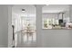 Open-concept dining area with a chandelier, large windows, and a view into the modern kitchen at 4718 Sleepy Falls Run, Knightdale, NC 27545