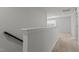 Upstairs hallway with carpet flooring, white walls and a staircase to the lower level at 4718 Sleepy Falls Run, Knightdale, NC 27545