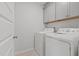 Laundry room featuring gray cabinets and modern appliances at 4718 Sleepy Falls Run, Knightdale, NC 27545