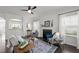 Bright living room with a fireplace, hardwood floors, and plenty of natural light from the large windows at 4718 Sleepy Falls Run, Knightdale, NC 27545