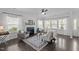 Cozy living room with a fireplace, large windows with curtains, and comfortable seating arrangements at 4718 Sleepy Falls Run, Knightdale, NC 27545