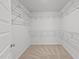 Empty walk-in closet with carpet flooring, white walls, and shelving for optimal storage at 4718 Sleepy Falls Run, Knightdale, NC 27545