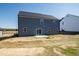 Exterior view of home showcasing backyard with sliding glass door and gray siding under a clear sky at 50 Rosewood Ln, Youngsville, NC 27596