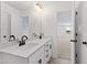 Bathroom featuring double sinks with vanity, framed mirror, and natural light at 50 Rosewood Ln, Youngsville, NC 27596