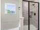 Bright white bathroom featuring a tub and shower stall with tile and a glass door at 50 Rosewood Ln, Youngsville, NC 27596