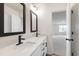 Bathroom featuring double sinks, quartz countertops, black fixtures, and contemporary mirrors at 50 Rosewood Ln, Youngsville, NC 27596