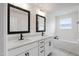 Bright bathroom featuring double vanity, black fixtures, and soaking tub with natural light at 50 Rosewood Ln, Youngsville, NC 27596