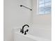 Soaking tub with black fixtures and a window, creating a spa-like atmosphere in the bathroom at 50 Rosewood Ln, Youngsville, NC 27596