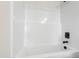 New bathtub with black fixtures and pristine white surround, ready for relaxation at 50 Rosewood Ln, Youngsville, NC 27596