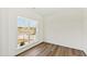 Well-lit room with hardwood floors and large window offering a peaceful view at 50 Rosewood Ln, Youngsville, NC 27596