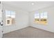 Bright, carpeted bedroom features two windows, neutral paint, and a large closet at 50 Rosewood Ln, Youngsville, NC 27596