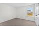 Bedroom featuring plush carpeting, crisp white walls, and a window for natural light at 50 Rosewood Ln, Youngsville, NC 27596