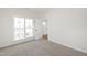 Bright bedroom with a carpeted floor, large window, and an open doorway at 50 Rosewood Ln, Youngsville, NC 27596