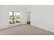 Bright bedroom featuring carpet floors, a large window and a white door at 50 Rosewood Ln, Youngsville, NC 27596