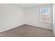 Neutral bedroom with carpet, large window allowing in natural light, and crisp white walls at 50 Rosewood Ln, Youngsville, NC 27596