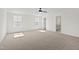Bonus room with plush carpeting, crisp white walls, and natural light from two windows at 50 Rosewood Ln, Youngsville, NC 27596
