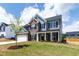 Charming two-story home with brick, gray siding, a white garage door, and lush green lawn at 50 Rosewood Ln, Youngsville, NC 27596