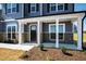View of the home's covered front porch with white columns, gray siding and brick accents at 50 Rosewood Ln, Youngsville, NC 27596