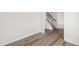 Hallway with hardwood floors, white walls, and staircase at 50 Rosewood Ln, Youngsville, NC 27596