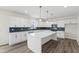 Bright kitchen features white cabinets, quartz countertops and island with modern stainless appliances at 50 Rosewood Ln, Youngsville, NC 27596