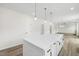 Open kitchen view with a large island illuminated by pendant lights, and stainless appliances at 50 Rosewood Ln, Youngsville, NC 27596