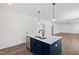 Modern kitchen island features stainless steel appliances, black faucet, and pendant lighting at 50 Rosewood Ln, Youngsville, NC 27596
