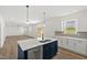Spacious kitchen with stainless appliances, white cabinets, and a large kitchen island at 50 Rosewood Ln, Youngsville, NC 27596