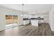 Modern kitchen featuring white cabinets, dark backsplash, and large island with sliding door access at 50 Rosewood Ln, Youngsville, NC 27596
