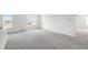 Spacious, open-concept living area with plush carpet and natural light at 50 Rosewood Ln, Youngsville, NC 27596