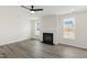 Bright living room showcasing a fireplace flanked by large windows offering abundant natural light at 50 Rosewood Ln, Youngsville, NC 27596
