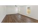 Open living room with modern floors, large windows and a ceiling fan at 50 Rosewood Ln, Youngsville, NC 27596