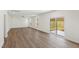 Bright living room featuring contemporary vinyl floors, fresh paint, and a sliding glass door at 50 Rosewood Ln, Youngsville, NC 27596