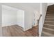 Spacious living room featuring wood floors and staircase access at 50 Rosewood Ln, Youngsville, NC 27596