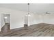 Spacious living room with hardwood floors, modern lighting, and open doorways at 50 Rosewood Ln, Youngsville, NC 27596
