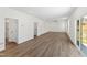 Spacious living room with modern vinyl floors and a sliding glass door to the backyard at 50 Rosewood Ln, Youngsville, NC 27596