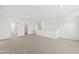 Upstairs loft area featuring neutral carpet, white walls and trim, and access to several bedrooms at 50 Rosewood Ln, Youngsville, NC 27596