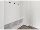White mudroom with hooks, bench and storage below, perfect for organizing your gear at 50 Rosewood Ln, Youngsville, NC 27596