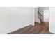 Clean room featuring hard wood flooring with a view of the stairway at 50 Rosewood Ln, Youngsville, NC 27596