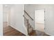 Hallway view features a carpeted staircase with wooden banister, enhancing the home's charm at 50 Rosewood Ln, Youngsville, NC 27596