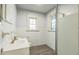 Bathroom featuring shower, toilet, and sink with white tile walls at 500 Cokey Rd, Rocky Mount, NC 27801