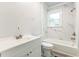 Bathroom with marble wall tile and white fixtures including toilet, tub, and sink at 500 Cokey Rd, Rocky Mount, NC 27801