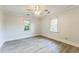 Spacious bedroom featuring wood-look flooring, neutral walls, and a ceiling fan at 500 Cokey Rd, Rocky Mount, NC 27801