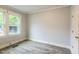 Cozy bedroom with gray flooring, a window offering natural light, and neutral paint at 500 Cokey Rd, Rocky Mount, NC 27801