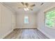 Bright bedroom with ceiling fan, neutral paint, gray flooring, and natural lighting at 500 Cokey Rd, Rocky Mount, NC 27801