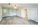 Neutrally painted bedroom with wood-look floors, ceiling fan and access to more rooms at 500 Cokey Rd, Rocky Mount, NC 27801