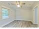 Bright bedroom features wood floors, neutral paint, ceiling fan, and ample natural light at 500 Cokey Rd, Rocky Mount, NC 27801