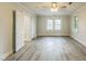 Brightly lit bedroom with wood-look floors, neutral paint and multiple doorways at 500 Cokey Rd, Rocky Mount, NC 27801