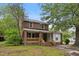 Charming two-story brick home with a welcoming front porch and mature trees at 500 Cokey Rd, Rocky Mount, NC 27801