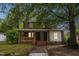 Charming two-story brick home with a welcoming front porch and mature trees at 500 Cokey Rd, Rocky Mount, NC 27801
